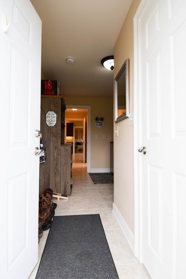 corridor with light tile patterned flooring