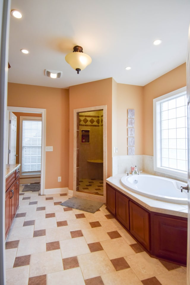 bathroom with separate shower and tub and vanity