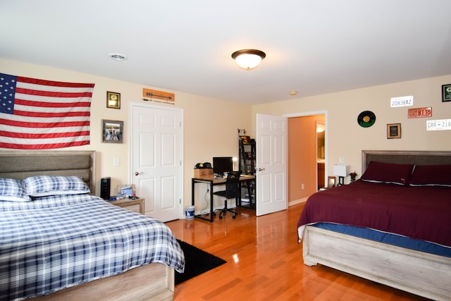 bedroom with hardwood / wood-style flooring