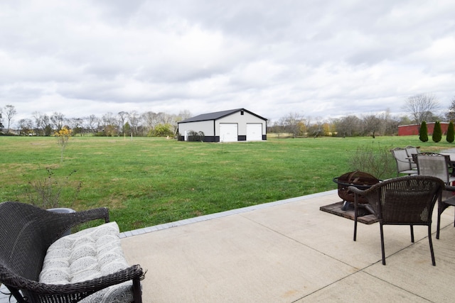 view of patio with a garage and an outbuilding