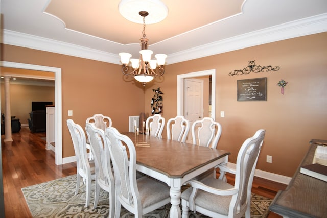 dining area featuring a notable chandelier, crown molding, and dark hardwood / wood-style floors