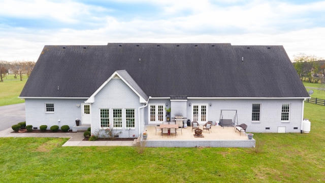 back of house featuring a lawn, french doors, and a patio