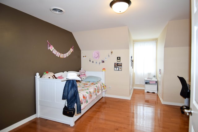 bedroom with hardwood / wood-style floors