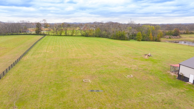 drone / aerial view featuring a rural view and a water view