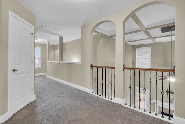 hallway with beam ceiling, carpet floors, and coffered ceiling