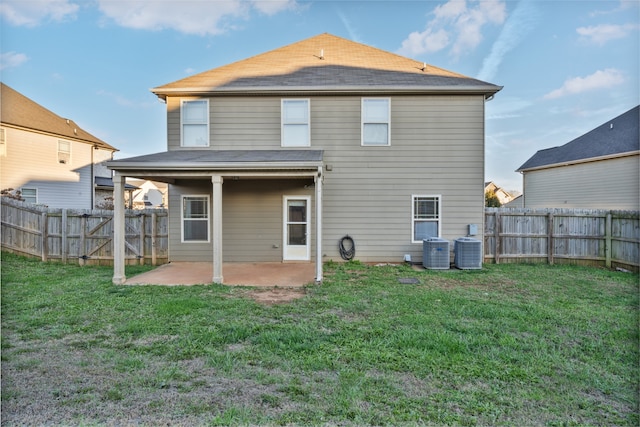 back of property featuring a lawn, a patio, and central AC