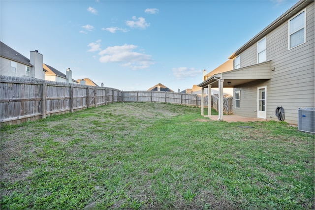 view of yard with a patio area and central air condition unit