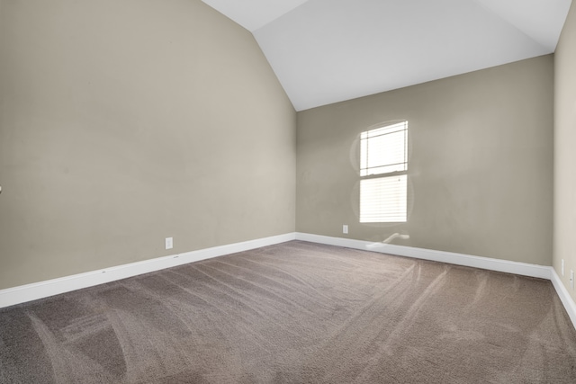 unfurnished room featuring carpet flooring and vaulted ceiling