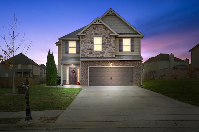 view of front of house featuring a lawn and a garage