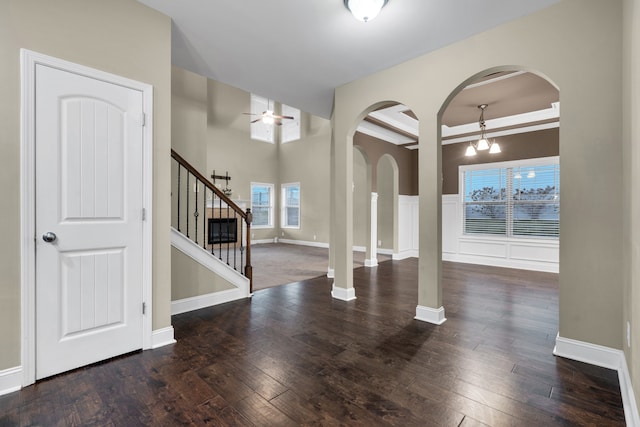 entrance foyer with beamed ceiling, plenty of natural light, dark wood-type flooring, and ceiling fan with notable chandelier