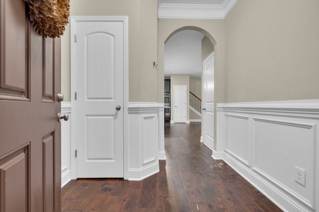 corridor featuring dark hardwood / wood-style floors and ornamental molding