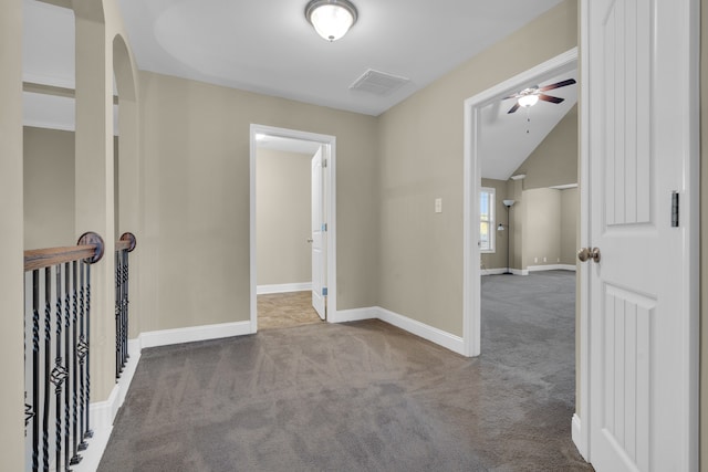 corridor with light colored carpet and lofted ceiling