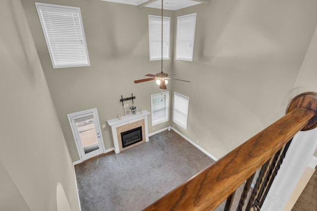 living room with ceiling fan and dark carpet