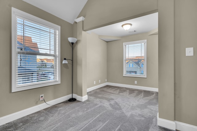 unfurnished room with carpet floors and lofted ceiling