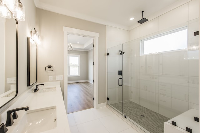 bathroom with a chandelier, wood-type flooring, an enclosed shower, vanity, and ornamental molding