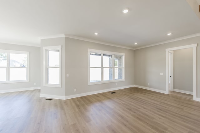 unfurnished living room with light hardwood / wood-style floors and ornamental molding