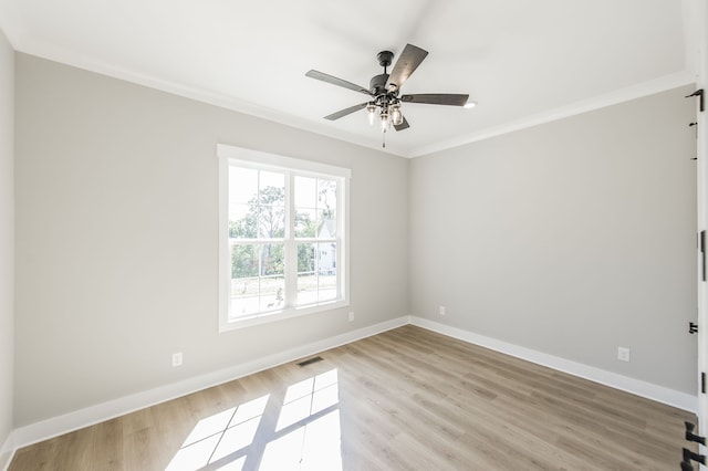 empty room featuring ceiling fan, light hardwood / wood-style floors, and ornamental molding