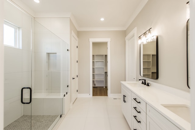 bathroom with tile patterned floors, vanity, crown molding, and walk in shower