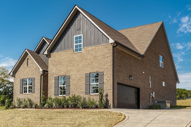 view of side of property featuring a garage and central air condition unit