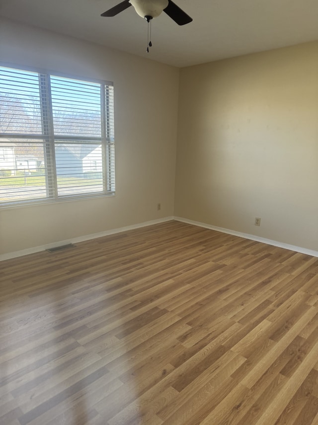 spare room featuring hardwood / wood-style floors and ceiling fan