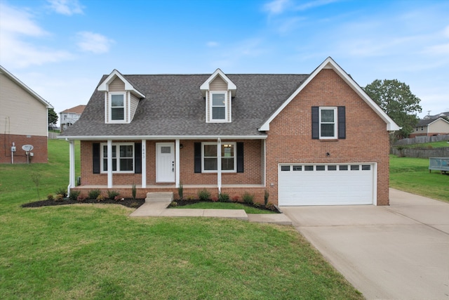 view of front of home with covered porch, a garage, and a front yard