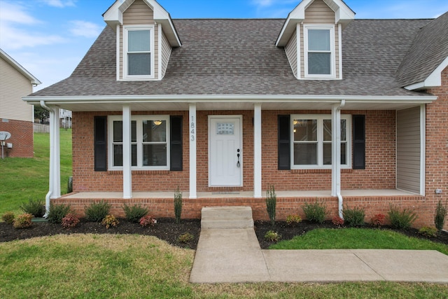 view of front of property with a porch and a front lawn