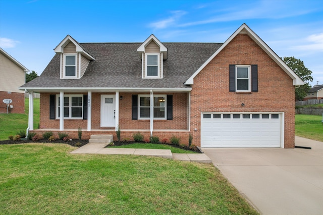 view of front of home with a front lawn, a porch, and a garage