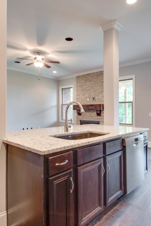 kitchen featuring ceiling fan, dishwasher, sink, light stone counters, and dark hardwood / wood-style floors