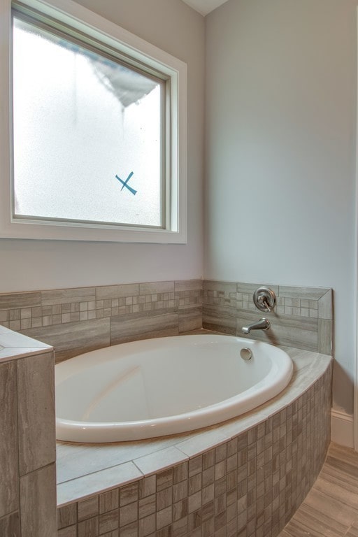 bathroom with tiled tub