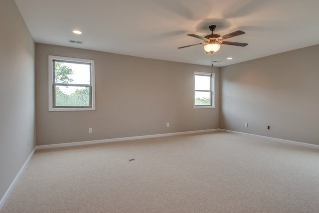 unfurnished room with ceiling fan and light colored carpet