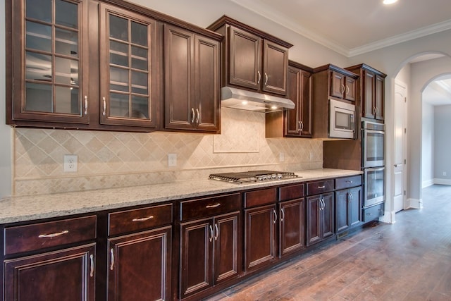 kitchen with dark brown cabinetry, dark hardwood / wood-style flooring, and ornamental molding