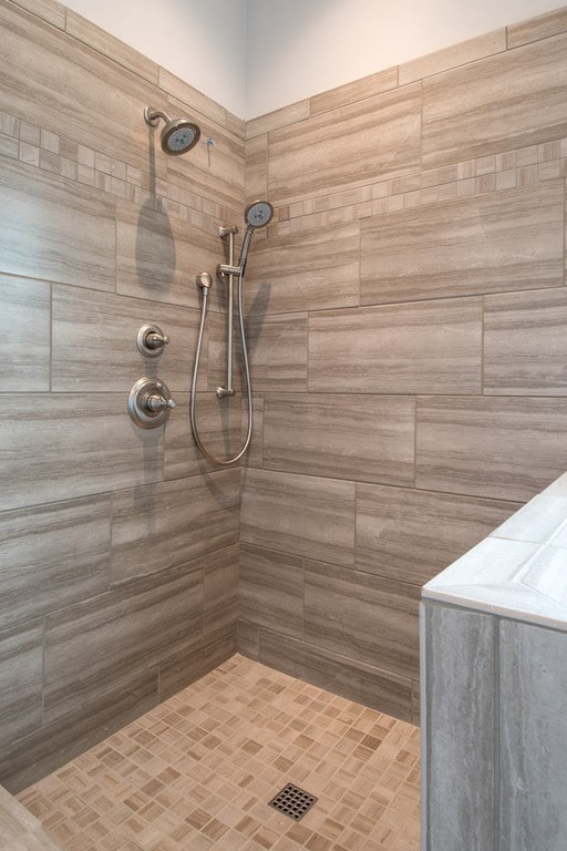 bathroom with tiled shower