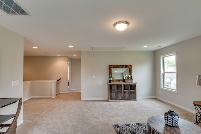 sitting room featuring light carpet