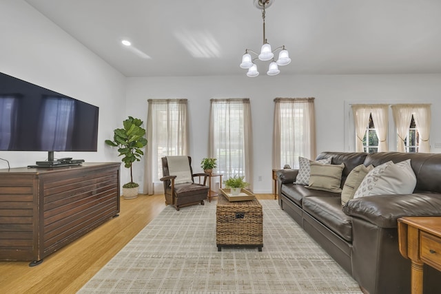 living room featuring an inviting chandelier and light hardwood / wood-style flooring