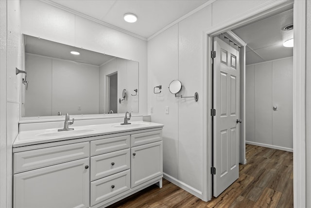 bathroom with vanity, ornamental molding, and hardwood / wood-style flooring