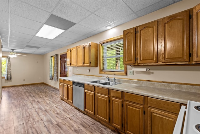 kitchen featuring ceiling fan, sink, stainless steel dishwasher, white range, and light hardwood / wood-style floors