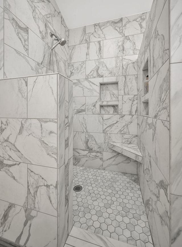 bathroom with a tile shower