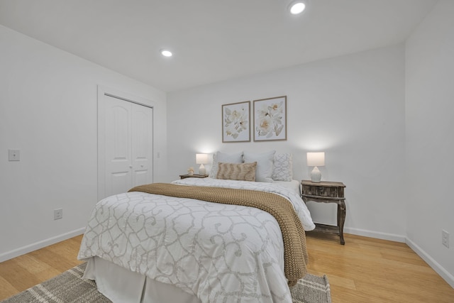 bedroom featuring light hardwood / wood-style floors and a closet