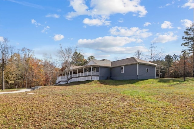 view of side of home featuring a yard and a sunroom