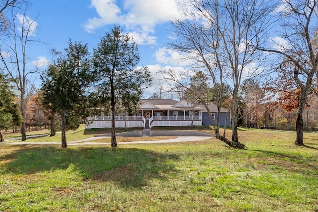 exterior space with covered porch and a front yard