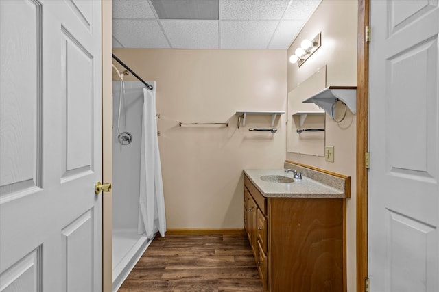 bathroom with vanity, hardwood / wood-style floors, a paneled ceiling, and a shower with shower curtain