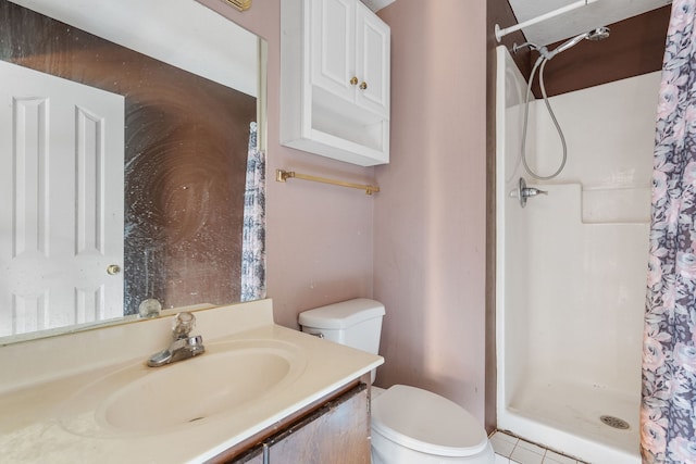 bathroom featuring tile patterned floors, vanity, toilet, and walk in shower