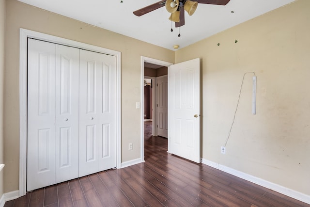 unfurnished bedroom featuring a closet, dark hardwood / wood-style floors, and ceiling fan