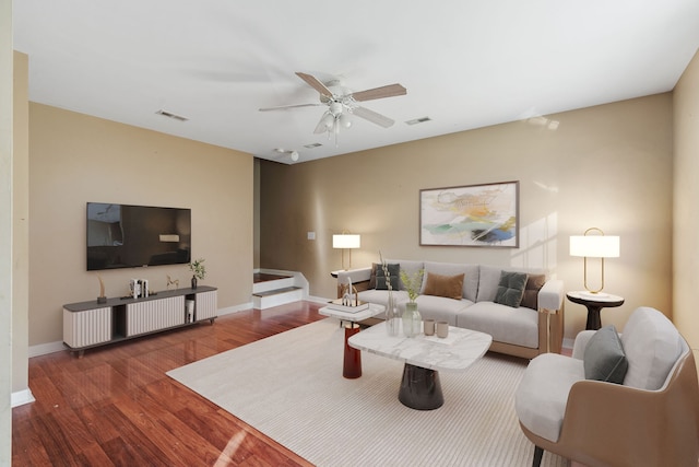 living room featuring dark hardwood / wood-style floors and ceiling fan