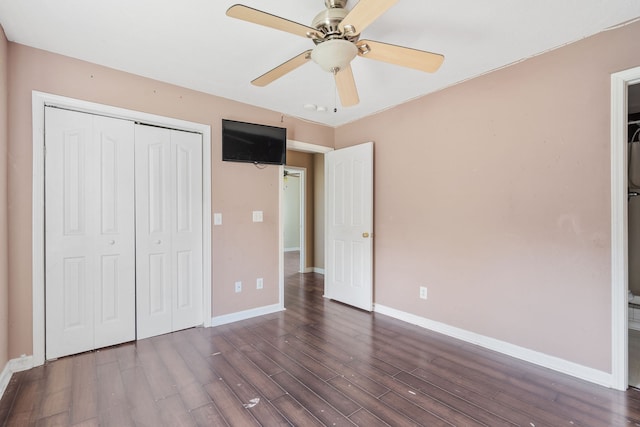 unfurnished bedroom with a closet, ceiling fan, and dark wood-type flooring