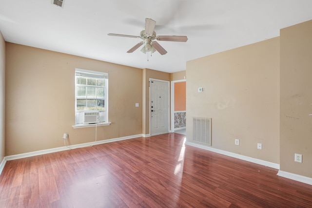 spare room with hardwood / wood-style flooring, ceiling fan, and cooling unit