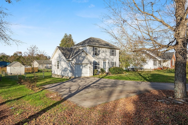 view of front of home with a garage and a front lawn