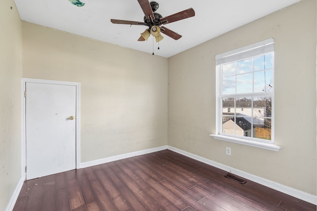 spare room featuring ceiling fan and dark wood-type flooring