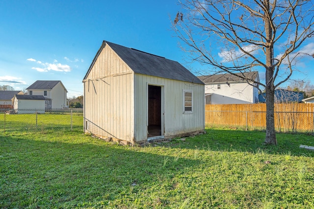 view of outbuilding with a yard