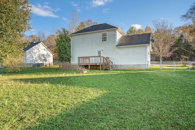 back of house with a yard and a wooden deck